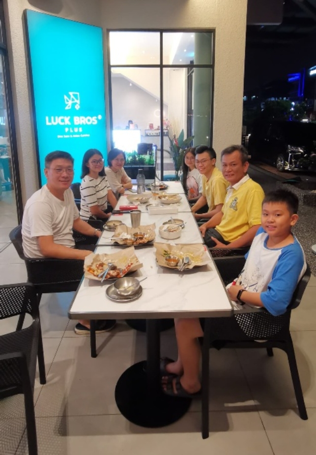 A group of people sitting at a tableDescription automatically generated